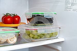 Storage containers with fresh food in a fridge