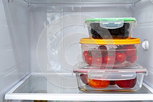 Storage containers with fresh food in a fridge