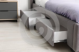 Storage drawers for bedding under modern bed in room