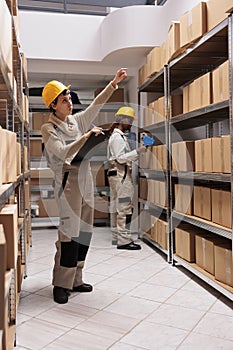 Storage employees coordinating shipping and preparing boxes before transportation