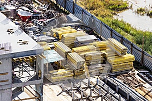 Storage of equipment and materials at the construction site. Formwork elements and building materials prepared for the