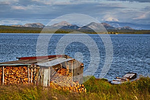 Storage for firewood on the shore of a mountain lake. Vera Island IMG4594