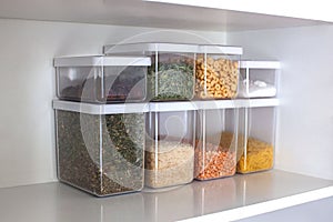 Storage ideas in the kitchen. White box and basket. Shelf order system.