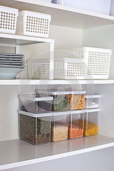 Storage ideas in the kitchen. White box and basket. Shelf order system.