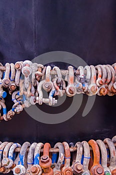 Storage of old rusty shackles. Metallic connectors for chains an