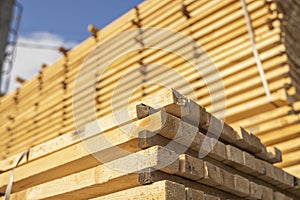 Storage of piles of wooden boards on the sawmill. Boards are stacked in a carpentry shop. Sawing drying and marketing of