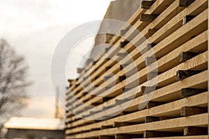 Storage of piles of wooden boards on the sawmill. Boards are stacked in a carpentry shop. Sawing drying and marketing of