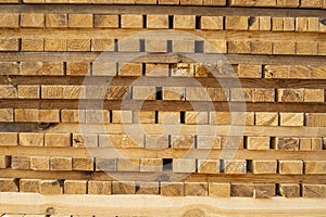 Storage of piles of wooden boards on the sawmill. Boards are stacked in a carpentry shop. Sawing drying and marketing of