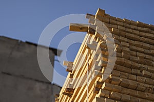 Storage of piles of wooden boards on the sawmill. Boards are stacked in a carpentry shop. Sawing drying and marketing of