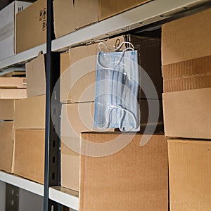 Storage of protective face masks in a warehouse among cardboard boxes