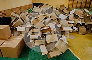 The storage room area is filled with empty cardboard boxes. a large group of used cardboard boxes