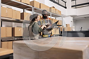 Storage room coworkers searching parcel using checklist