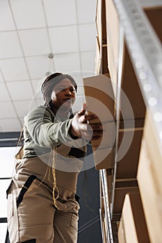 Storage room worker employee taking out cardboard boxes