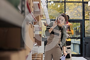 Storage room worker having remote conversation