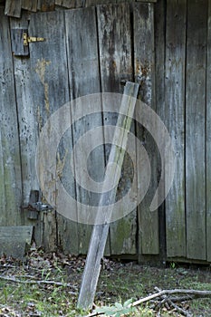 Storage shed door with board propped against it