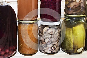 Storage shelves in pantry with homemade canned preserved fruits and vegetables