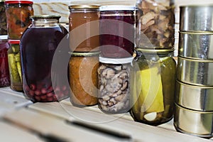 Storage shelves in pantry with homemade canned preserved fruits and vegetables