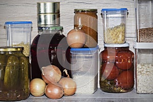 Storage shelves in pantry with homemade canned preserved fruits and vegetables
