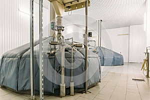 Storage steel tanks or cisterns and pipes for beer fermentation in industrial brewery production factory