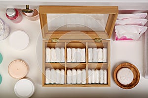 Storage of tampons and different hygiene products in white drawer, flat lay