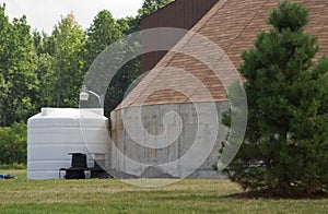 Storage tank beside building