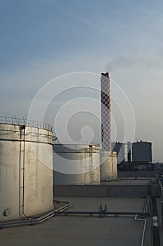 Storage Tanks And Smokestack Of Oil Industry