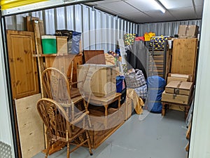 Self storage unit clearance packing furniture into room photo