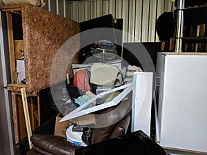 A self storage unit full of stored household junk items photo