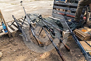 Storage of various guns and rifles on firing range. Military equipment ammunition and weaponry. Horizontal shot.