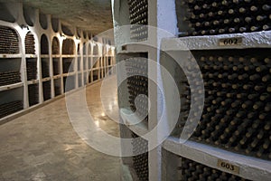 The storage of wine bottles in a wine cellar.