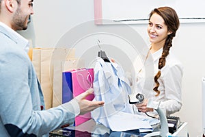 Store clerk serving purchaser