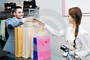 Store clerk serving purchaser