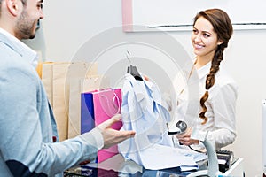 Store clerk serving purchaser photo