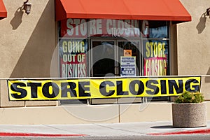 Store Closing and Going out of Business signs displayed at a soon to be closed store I