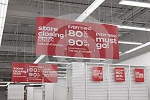 Store Closing and huge discount signs displayed at a soon to be out of business clearance sale. Everything must go.