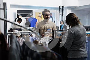 Store consultant guiding customer photo