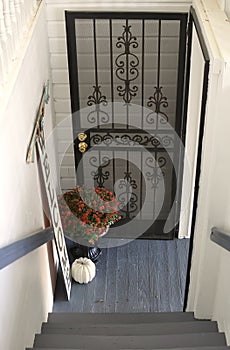 Store entrance with black wrought iron door and welcome sign