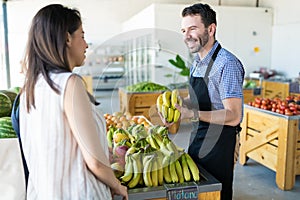 Store Owner Promoting Healthful Fruits In Shop