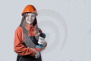 A store that sells tools. Girl with a working tool on a white background