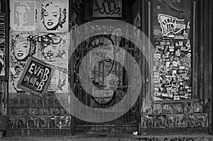 Storefront plastered with graffiti and posters