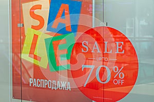 Storefronts with sale sign behind the glass window