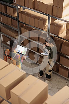 Storehouse worker doing products inventory on tablet