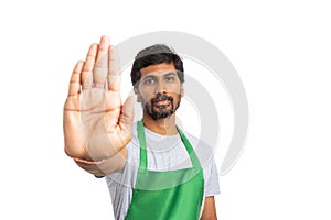 Storekeeper holding palm as stop gesture