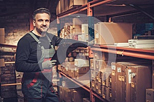 Storekeeper with manual pick list on a warehouse photo