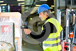 Storeman with scanner at warehouse of forwarding