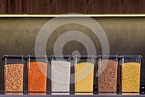 Storing groceries in polypropylene boxes according to the Konmari method in the kitchen. Placing, sorting, storing products in