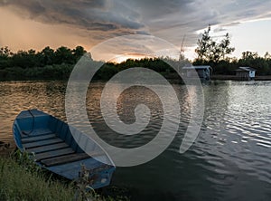 Storm arcus shaft and cumulonimbus cloud with heavy rain or summer shower, severe weather and sun glow behind rain. Landscape with