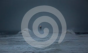 Storm Arwen batters the coastline at Tynemouth, England, with giant waves crashing against the lighthouse in the gale force winds