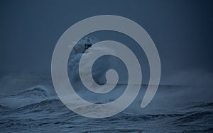 Storm Arwen batters the coastline at Tynemouth, England, with giant waves crashing against the lighthouse in the gale force winds