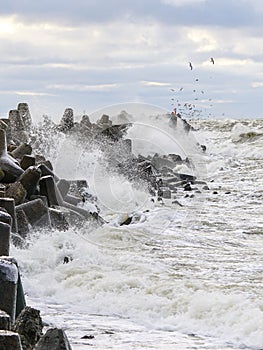 Storm on the Baltic coast, waves hitting the breakwater concrete tetrapods